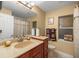Well-lit bathroom featuring warm tones, a vanity, and a window for natural light at 4320 Sw 112Th St, Ocala, FL 34476