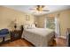 Comfortable bedroom with hardwood floors, a ceiling fan, and a large window at 4320 Sw 112Th St, Ocala, FL 34476