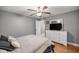 Well-lit bedroom features neutral colors, a ceiling fan, and includes a dresser and white accents at 4320 Sw 112Th St, Ocala, FL 34476