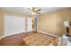 Bedroom featuring hardwood floors, a ceiling fan, and access to the ensuite bathroom at 4320 Sw 112Th St, Ocala, FL 34476