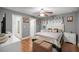 Well-lit bedroom features neutral colors, a ceiling fan, and includes a dresser and nightstand at 4320 Sw 112Th St, Ocala, FL 34476