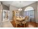 Formal dining area with classic furnishings, chandelier, and arched window with sheer curtains at 4320 Sw 112Th St, Ocala, FL 34476