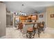 Bright, airy kitchen with granite countertops, stainless steel refrigerator, and tiled floors at 4320 Sw 112Th St, Ocala, FL 34476