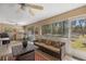 Comfortable lanai with a ceiling fan, sofa, table, grill, and outdoor kitchen at 4320 Sw 112Th St, Ocala, FL 34476
