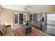 Inviting screened lanai with a ceiling fan, sofas, and an outdoor refrigerator at 4320 Sw 112Th St, Ocala, FL 34476