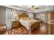 Elegant main bedroom with wood floors, ceiling fan, and large windows at 4320 Sw 112Th St, Ocala, FL 34476
