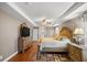 Elegant main bedroom featuring a tray ceiling, ceiling fan, and a large dresser at 4320 Sw 112Th St, Ocala, FL 34476