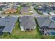 Aerial view of a home featuring a well-manicured lawn and screened in porch at 4384 Pezzullo Cir, The Villages, FL 32163
