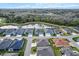 Aerial view of houses with backyard pond views, sidewalks, and lush surroundings at 4384 Pezzullo Cir, The Villages, FL 32163