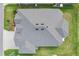 An aerial view of a home with a modern roof, well maintained landscaping and a concrete driveway at 4384 Pezzullo Cir, The Villages, FL 32163