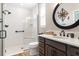 Modern bathroom features frameless glass shower, tile floor, and vanity with a decorative mirror at 4384 Pezzullo Cir, The Villages, FL 32163