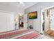 Bright bedroom features ceiling fan, closet, tv, and doorway access to en suite bathroom at 4384 Pezzullo Cir, The Villages, FL 32163
