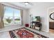 Cozy bedroom with a large window, ceiling fan, and an ornate area rug at 4384 Pezzullo Cir, The Villages, FL 32163