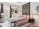 Comfortable bedroom features stylish decor, ceiling fan, large window, and a cozy bed at 4384 Pezzullo Cir, The Villages, FL 32163