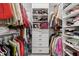 Walk-in closet with organized shelving, drawers and hanging racks for efficient storage and organization at 4384 Pezzullo Cir, The Villages, FL 32163