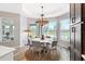 Bright dining room with decorative chandelier, hardwood floors and views of the surrounding area at 4384 Pezzullo Cir, The Villages, FL 32163