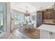 Bright dining room with decorative chandelier, hardwood floors and views of the surrounding area at 4384 Pezzullo Cir, The Villages, FL 32163