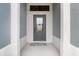 Welcoming front entryway with a stylish glass-paneled door and crisp white trim at 4384 Pezzullo Cir, The Villages, FL 32163