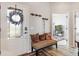 View of the entryway featuring bench seating, coat hooks and a glimpse into the adjacent room at 4384 Pezzullo Cir, The Villages, FL 32163