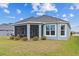 Exterior rear view of the home highlighting the beautiful outdoor living space with a screened in porch at 4384 Pezzullo Cir, The Villages, FL 32163