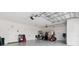 Spacious three car garage with epoxy flooring, high ceilings, storage, and a golf cart at 4384 Pezzullo Cir, The Villages, FL 32163