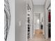 Hallway featuring an open linen closet with fresh towels and a view to the ensuite bathroom at 4384 Pezzullo Cir, The Villages, FL 32163