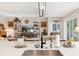 Modern kitchen island with stainless steel sink and black faucet overlooking the Gathering room and backyard at 4384 Pezzullo Cir, The Villages, FL 32163