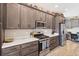 Elegant kitchen boasts stainless steel appliances, wood cabinets, and white countertops at 4384 Pezzullo Cir, The Villages, FL 32163