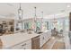Spacious open-concept kitchen with seating, stainless steel appliances, and a nearby dining area at 4384 Pezzullo Cir, The Villages, FL 32163