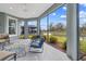 Cozy enclosed lanai seating and gorgeous views of the beautiful backyard and lake at 4384 Pezzullo Cir, The Villages, FL 32163