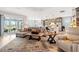 Open concept living room boasts a comfortable seating area, neutral decor, and easy access to the outdoor space at 4384 Pezzullo Cir, The Villages, FL 32163