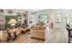 Bright living room is decorated in neutral earth tones, with an adjacent kitchen at 4384 Pezzullo Cir, The Villages, FL 32163
