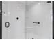 Modern shower features sleek, white subway tile, matte black hardware, and frameless glass door at 4384 Pezzullo Cir, The Villages, FL 32163