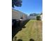 Spacious backyard with lush green grass and a white fence at 4954 Sw 40Th Pl, Ocala, FL 34474