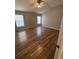Bedroom with wood floors, ceiling fan and two windows at 4954 Sw 40Th Pl, Ocala, FL 34474