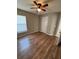 Bedroom with wood floors, ceiling fan, and one window at 4954 Sw 40Th Pl, Ocala, FL 34474
