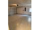 Spacious and empty two-car garage featuring an automatic door and side entrance, ready for parking and storage at 4954 Sw 40Th Pl, Ocala, FL 34474