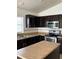 This kitchen features dark cabinets, stainless steel appliances and a window over the sink at 4954 Sw 40Th Pl, Ocala, FL 34474