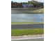 Scenic view of a lake with colorful buildings in the background at 4954 Sw 40Th Pl, Ocala, FL 34474