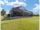 Large backyard with a screened-in patio perfect for relaxing and entertaining at 5111 Nw 35Th Pl, Ocala, FL 34482