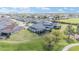 Aerial view of the backyard featuring a lush lawn and screened patio with views of the surrounding neighborhood at 5111 Nw 35Th Pl, Ocala, FL 34482
