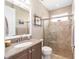 Bathroom featuring a glass-enclosed shower, granite vanity, and neutral tile flooring at 5111 Nw 35Th Pl, Ocala, FL 34482