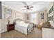 A well-lit bedroom with a metal frame bed, soft carpet, and tasteful decor at 5111 Nw 35Th Pl, Ocala, FL 34482
