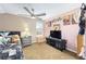 Quirky bedroom with carpet, pink walls, and featuring entertainment console at 5111 Nw 35Th Pl, Ocala, FL 34482