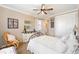 Cozy bedroom featuring a decorative dresser, plush bedding, and a comfortable wicker rocking chair at 5111 Nw 35Th Pl, Ocala, FL 34482
