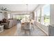Bright dining area featuring a wood table, elegant chairs, and a seamless transition to the outdoor living space at 5111 Nw 35Th Pl, Ocala, FL 34482