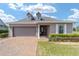 Charming single-story home with well-maintained landscaping, brick walkway, and a two-car garage at 5111 Nw 35Th Pl, Ocala, FL 34482
