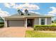 Charming one-story home featuring a brick driveway, well-manicured landscaping, and a two-car garage at 5111 Nw 35Th Pl, Ocala, FL 34482