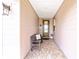 Inviting front porch with a bench, tile flooring, and a decorative front door at 5111 Nw 35Th Pl, Ocala, FL 34482