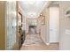 Inviting home hallway with wood floors, stylish rug, and elegant decor setting a warm ambiance at 5111 Nw 35Th Pl, Ocala, FL 34482